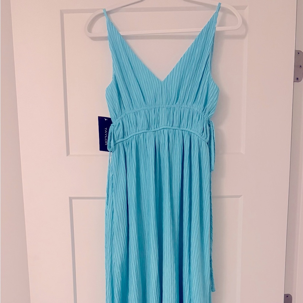 Brand new, teal blue spaghetti strap dress with high slits on both sides.